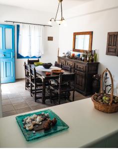 a kitchen with a table with a plate of food at Villa Mariza Kythnos in Kithnos