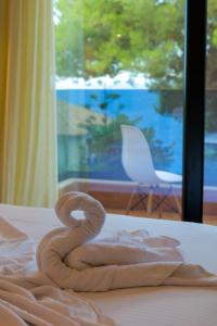 a towel sitting on top of a bed at Hotel Havana in Sarandë