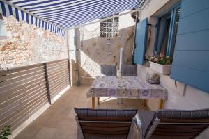 a patio with a table and chairs on a balcony at Pinea in Veli Lošinj