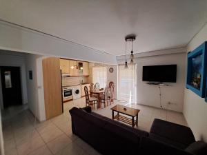 a living room with a couch and a table at Periklis House in Ixia