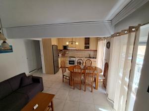a living room and kitchen with a table and chairs at Periklis House in Ixia +70 photos