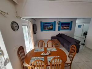 a dining room table and chairs in a living room at Periklis House in Ixia