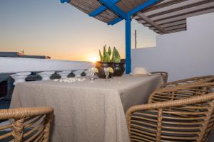 a table with two chairs and a plant on it at Kanelis Milos Sea Suite in Agia Irini Milos