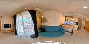 a living room with a blue couch and a desk at Goldie in Jezera