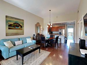 a living room with a blue couch and a table at Redfish Village m1-218 in Blue Mountain Beach