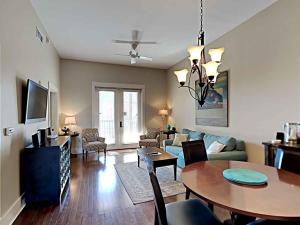 a living room with a table and a couch at Redfish Village m1-218 in Blue Mountain Beach