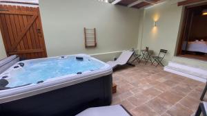a jacuzzi tub in a room with a table at Andros 4 All Seasons Villas & Suites in Andros