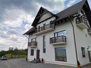 a white house with a black roof at Vila President Sovata in Sovata