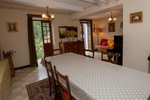 a dining room with a table and a living room at Hotel des Etrangers in Saint-Martin-dʼEntraunes