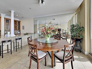 a kitchen and dining room with a table and chairs at Beach Club #1605C in Pensacola Beach