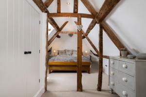sypialnia z łóżkiem na poddaszu w obiekcie Blenheim Cottage, Beautiful 15th Century Cotswold Cottage, 4 Bed, Nr Chipping Campden w mieście Mickleton