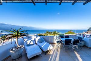 a balcony with blue furniture and a view of the ocean at Penthouse 230m2 on the Sea in Plettenberg Bay