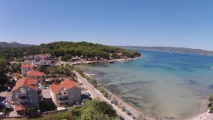 a view of a beach with houses and the water at Philomena Mobile home Camping Pasman in Pašman +7 photos