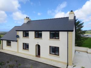 a detached house with a black roof at Jack's House in Glenties