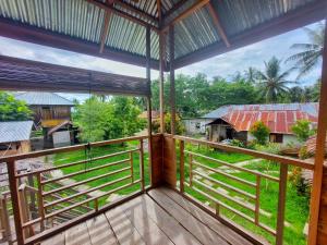 a balcony with a view of the jungle at Sunset Homestay by Harry & Mimin in Telaga