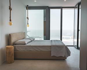 a bedroom with a bed and a window with a view at Seaside Resort in Trieste