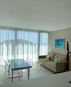 a living room with a couch and a glass table at Seaside Resort in Trieste