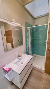 a bathroom with a sink and a shower and a mirror at Residence Al Lago in Castiglione del Lago