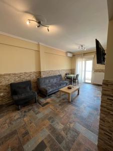 a living room with a couch and a table at Jacuzzi Suites in Thessaloniki