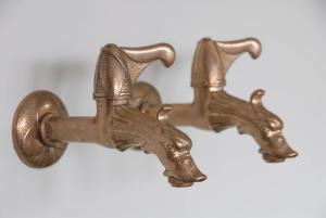 a pair of bronze handles on a wall at Treetop Apartment in The Hague