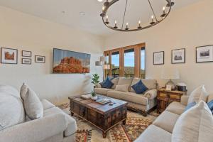 a living room with two couches and a table at Close to Fresh Creek! Sleeps 12 ~ Amazing Views w/Serene Open Space ~ Hot Tub + Game Room ~ Trails outside in Sedona