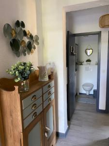 a kitchen with a dresser and a bathroom with a toilet at La Bastide de Jean Maison de charme dans un domaine equestre privé in Grasse