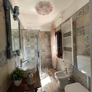 a bathroom with a sink and a toilet and a mirror at La Bricola in Cavallino-Treporti