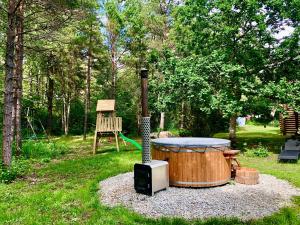 a stove with a drum in the grass at Kibuvitsa Holiday House in Muratsi