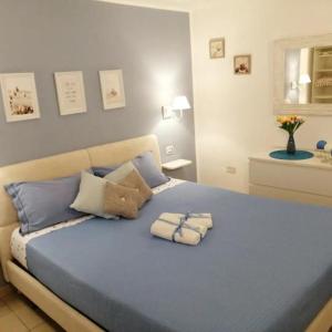 a bedroom with a blue bed with two pillows on it at Quattro Canti Valù in Palermo