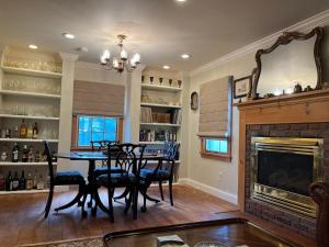 a dining room with a table and a fireplace at Come As You Are Inn LLC 