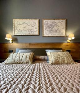 a bedroom with a bed with two pictures on the wall at Suite 29A Olbia Center in Olbia