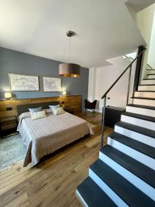 a bedroom with a bed and a staircase next to it at Suite 29A Olbia Center in Olbia