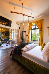 a bedroom with a large bed and a living room at Boutique Apartments Benz I-III in Bergisch Gladbach
