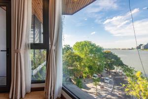 Cette chambre dispose d'une fenêtre avec vue sur l'eau. dans l'établissement Sunny Moon West Lake Apartment, à Hanoï