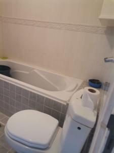 a bathroom with a toilet and a bath tub at Villa luxueuse et chaleureuse in Saïdia