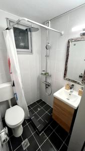 a bathroom with a white toilet and a sink at Su Casa KEA in Korissia +8 photos