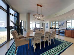 a dining room with a table and chairs at Capri #301 in Perdido Key