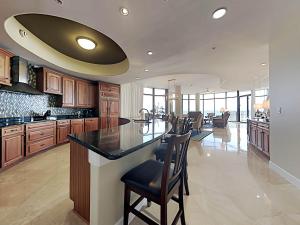 a large kitchen with a large island with bar stools at Capri #301 in Perdido Key +49 photos