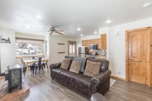 a living room with a leather couch and a table at Alpenglow Unit 6 in Ouray
