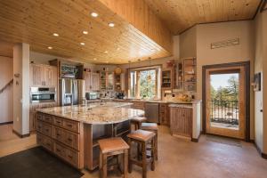 a large kitchen with a large center island with bar stools at Rincon Ridge Road in Durango