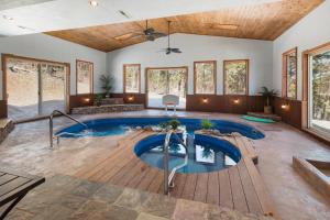 an indoor swimming pool with a deck and a large living room at Rincon Ridge Road in Durango