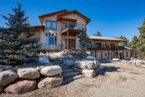 a large house with rocks in front of it at Rincon Ridge Road in Durango
