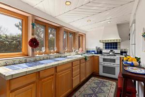 a kitchen with wooden cabinets and a stove top oven at 632 Old Santa Fe Trail in Santa Fe