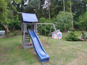 a playground with a slide and a play structure at KEJA Pustkowo in Pustkowo