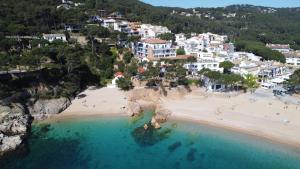 an aerial view of a beach with people in the water at Hotel Hostalillo by Escampa Hotels in Tamariu
