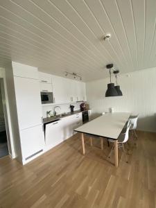 a kitchen with a table and chairs in a room at Voss, Øvre Tråstølen in Skulestadmo