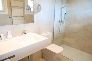 a bathroom with a toilet and a sink and a shower at Hotel Hostalillo by Escampa Hotels in Tamariu