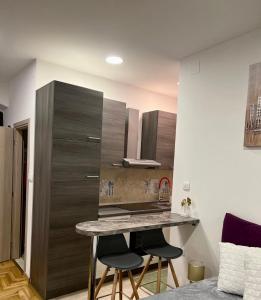 a kitchen with a table and two bar stools at Sweet studio apartment Living in Rijeka in Rijeka +46 photos
