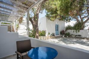 a patio with a blue table and two chairs at Hotel Mantalena in Antiparos Town