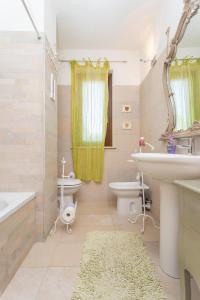 a bathroom with a sink and a tub and a toilet at La Casa Di Federica in Corciano